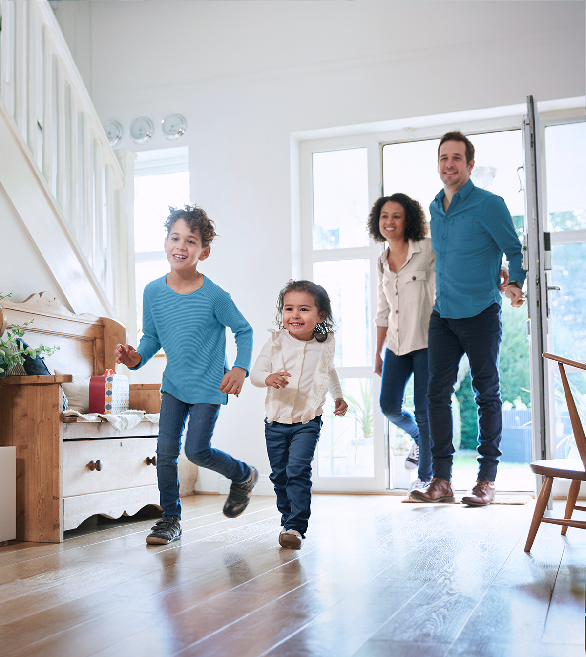 Family with two kids running indoors