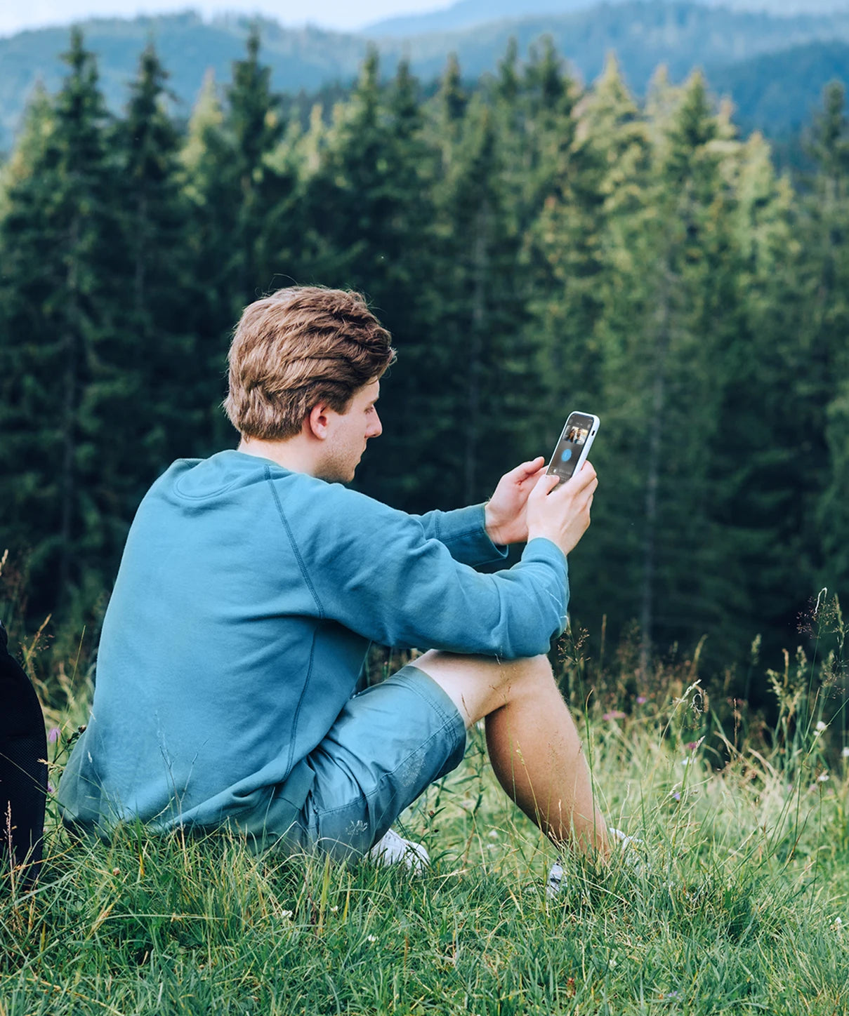 Man on his phone in the mountains