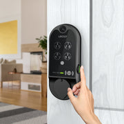 Black lockly smart lock with person using fingerprint scanner