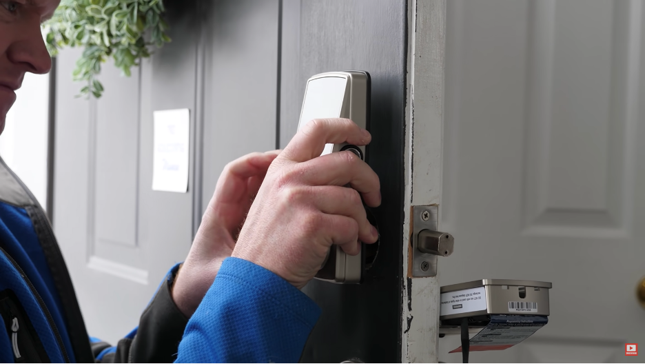 A person improving door lock security with a smart lock from Lockly.