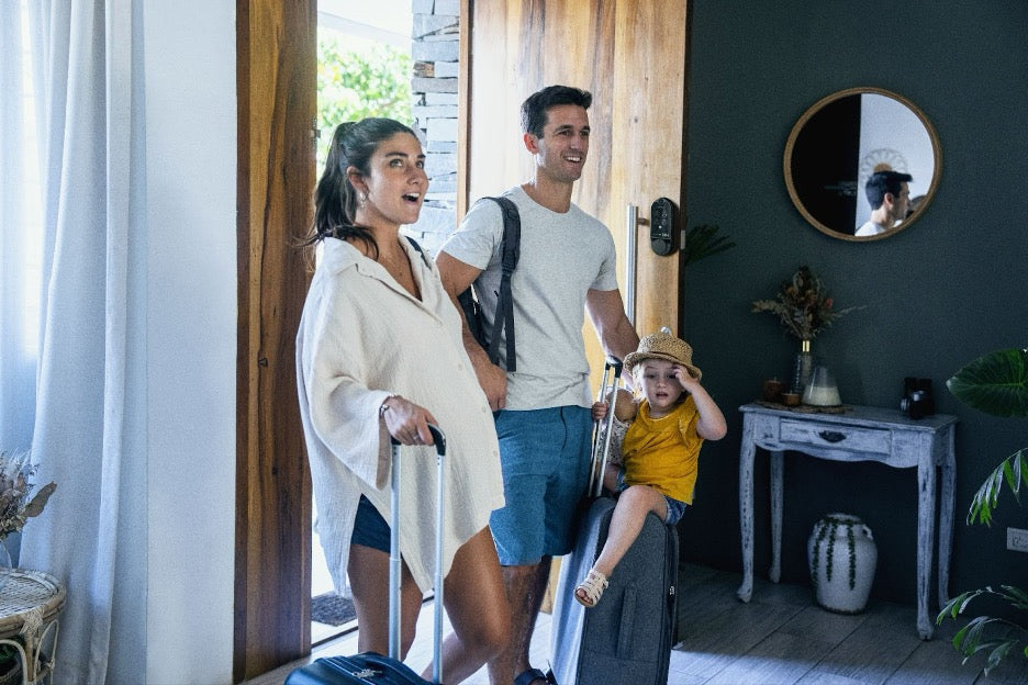 A family arriving at a rental property that has a smart lock.