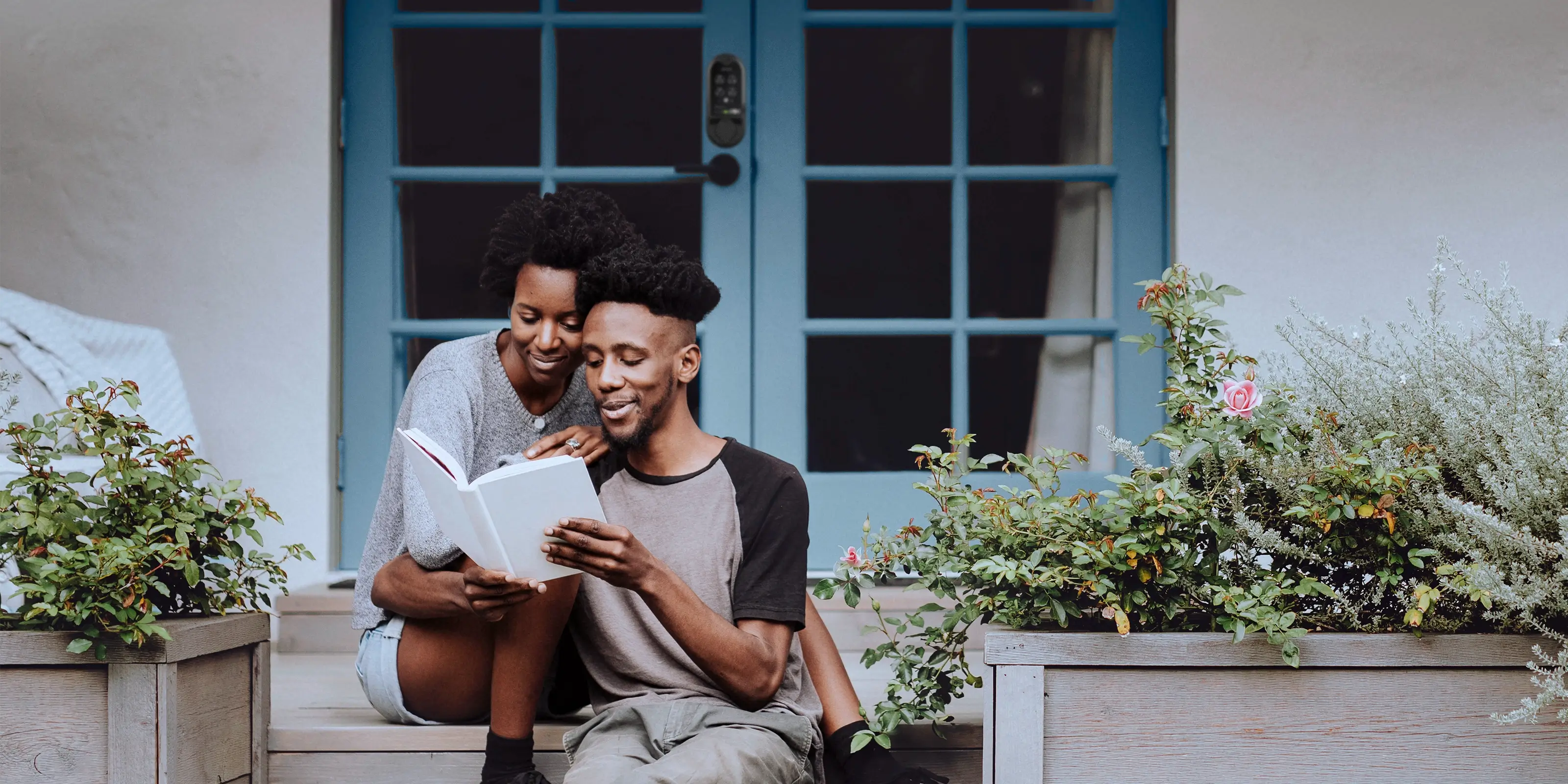 Couple sitting on their porch reading a book